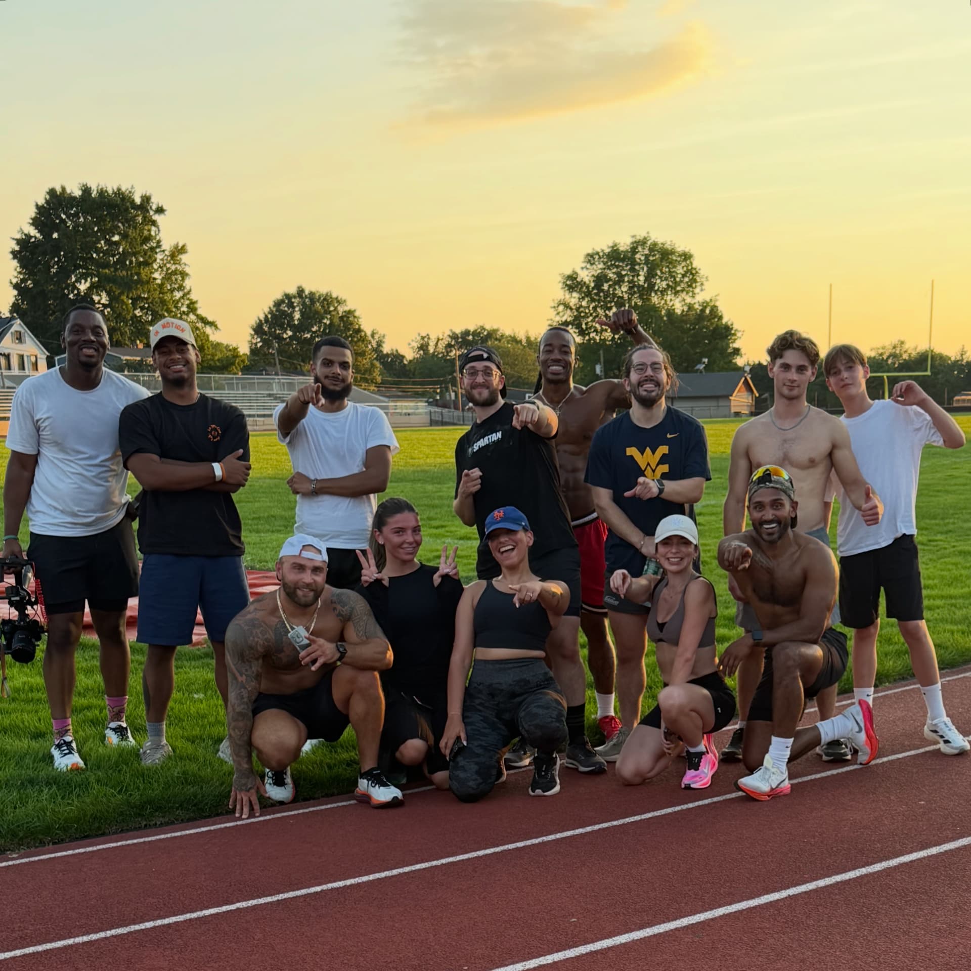 Runners on the track at sunset
